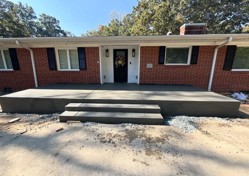 Wide concrete front porch with steps on a ranch home