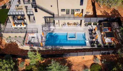 Aerial view of concrete pool decking and patios