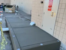 Commercial concrete landing poured along a building