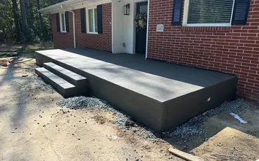 New concrete porch and steps at a brick home