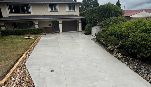 Long concrete driveway to a two-story home