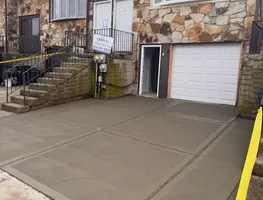 Fresh concrete driveway in front of a garage