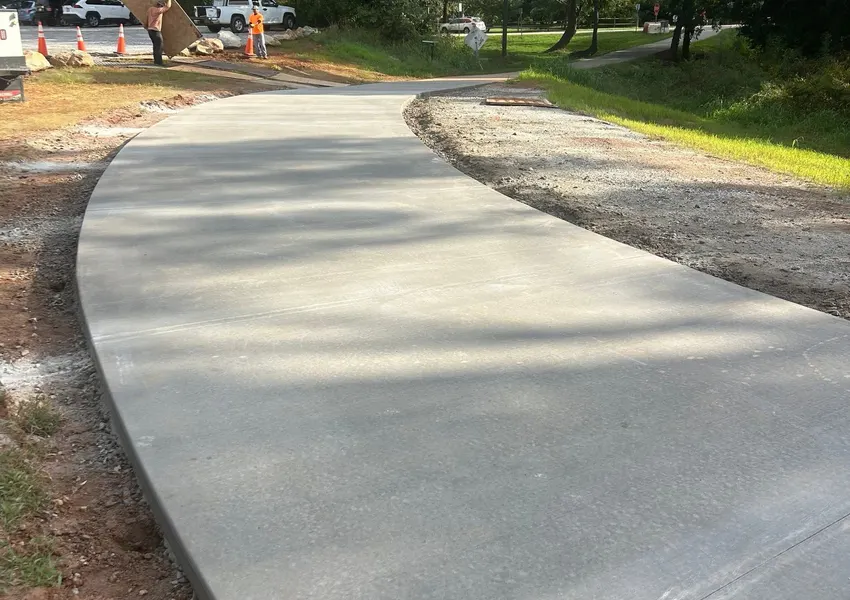 Long curved concrete walkway on a large lot