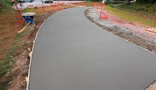 Curved concrete path between brick borders