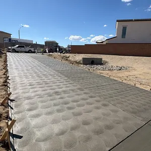 Broom-finish concrete path along a fence