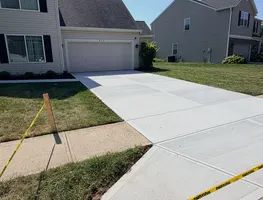 New concrete walkway connecting to a driveway