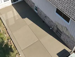 Side yard concrete walkway along a house