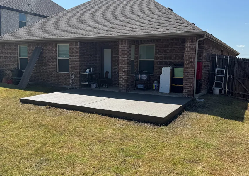 Concrete patio slab in a backyard lawn