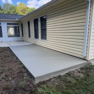 Side yard concrete patio along vinyl siding