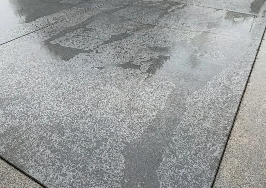 Freshly finished concrete slab measured for a pricing estimate