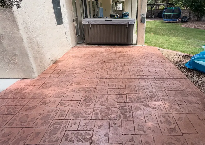 Stamped ashlar slate patio behind a Tulare home